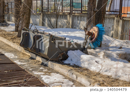 Abandoned Street Sweeper with Snow and Trees in a Urban Environment Capturing the Transition from Winter to Spring 140504479
