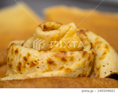 Rolled crepes stacked on plate, close-up view of homemade breakfast food Rolled crepes stacked on plate, close-up view of homemade breakfast food 140504681