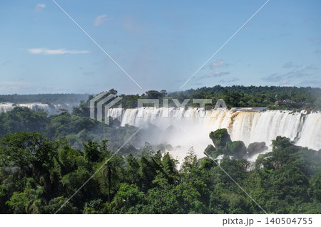 Majestic iguazu falls pouring huge waterfall into river surrounded by beautiful lush nature Majestic iguazu falls pouring huge waterfall into river surrounded by beautiful lush nature 140504755