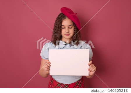 Young Girl Wearing a Red Beret Holding a Blank White Sign Against a Pink Wall Background Young Girl Wearing a Red Beret Holding a Blank White Sign Against a Pink Wall Background 140505218
