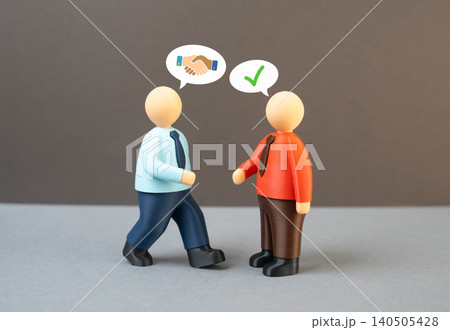 Two people in suits meet and shake hands. An employer and a job candidate. A greeting and job interview. 140505428