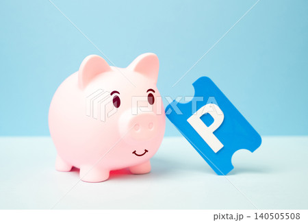 A piggy bank and a parking ticket. Saving on car parking. A piggy bank and a parking ticket. Saving on car parking. 140505508