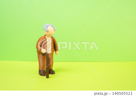 A grandfather and a place for dexterity. An elderly man with a cane. An old-fashioned suit. The older generation, the silent generation. 140505521