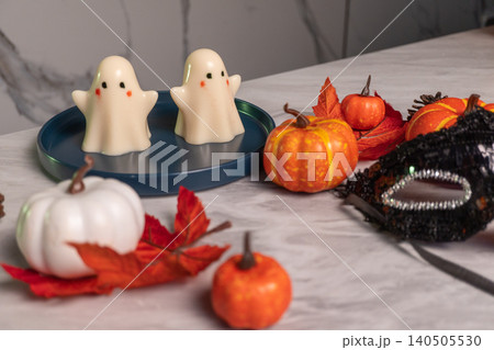 Halloween scene with ghost jellies and pumpkins on marble surface 140505530