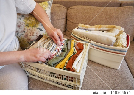 Organizing Fabrics and Textiles in a Cozy Living Space with Neat Baskets and Folded Cloths Organizing Fabrics and Textiles in a Cozy Living Space with Neat Baskets and Folded Cloths 140505654