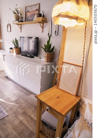 Bright and Inviting Living Room with Plants, Modern Decor, and Cozy Lighting for a Homey Atmosphere Bright and Inviting Living Room with Plants, Modern Decor, and Cozy Lighting for a Homey Atmosphere 140505670