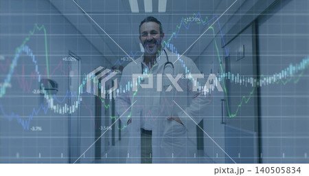 Standing male doctor wearing white lab coat and stethoscope in medical corridor, with market charts Standing male doctor wearing white lab coat and stethoscope in medical corridor, with market charts 140505834