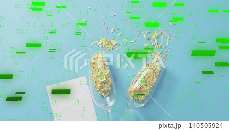 Showing two flutes with paper shreds on pale blue surface, green binary overlay, white card 140505924