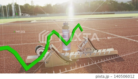 Showing starting blocks with water bottle resting on red athletics track, green graph overlay Showing starting blocks with water bottle resting on red athletics track, green graph overlay 140506012