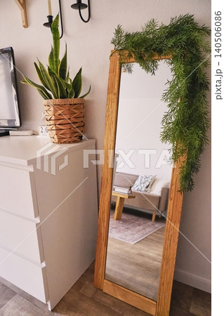 Stylish Home Decor Featuring a Full-Length Mirror with Greenery and Modern Living Space Background Stylish Home Decor Featuring a Full-Length Mirror with Greenery and Modern Living Space Background 140506086
