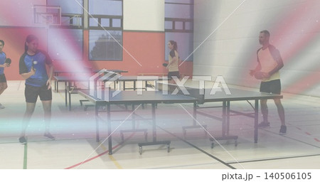 Playing players wearing sportswear hitting ball with table tennis paddles at central gym table Playing players wearing sportswear hitting ball with table tennis paddles at central gym table 140506105
