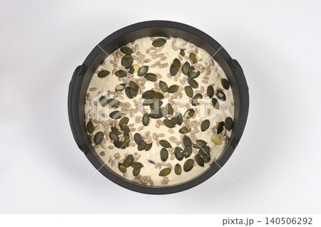 Unbaked Bread Dough with Seeds in Round Pan 140506292