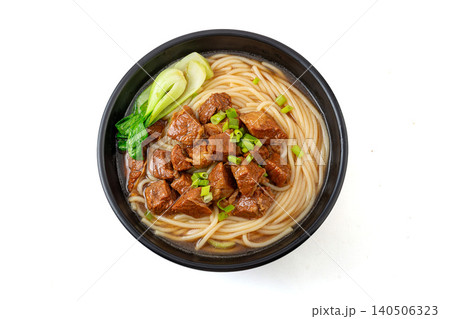 Traditional Chinese Braised Beef Rice Noodles with Bok Choy and Scallions. Authentic Asian Beef Noodle Soup in black Bowl. 140506323