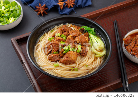 Traditional Chinese Braised Beef Rice Noodles with Bok Choy and Scallions. Authentic Asian Beef Noodle Soup in black Bowl. Traditional Chinese Braised Beef Rice Noodles with Bok Choy and Scallions. Authentic Asian Beef Noodle Soup in black Bowl. 140506328