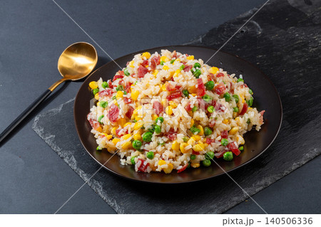 Fusion Fried Rice with Chinese Sausage, Corn, Green Peas and Melted Cheese. Creative Asian Stir-Fried Rice Bowl. Fusion Fried Rice with Chinese Sausage, Corn, Green Peas and Melted Cheese. Creative Asian Stir-Fried Rice Bowl. 140506336