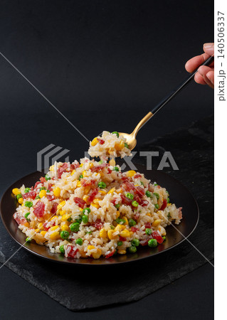 Fusion Fried Rice with Chinese Sausage, Corn, Green Peas and Melted Cheese. Creative Asian Stir-Fried Rice Bowl. Fusion Fried Rice with Chinese Sausage, Corn, Green Peas and Melted Cheese. Creative Asian Stir-Fried Rice Bowl. 140506337