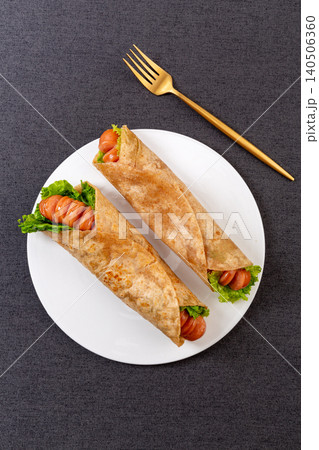 Whole Wheat Wrap with Grilled Sausage and Lettuce, Savory Snack Whole Wheat Wrap with Grilled Sausage and Lettuce, Savory Snack 140506360