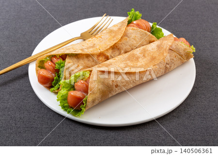 Whole Wheat Wrap with Grilled Sausage and Lettuce, Savory Snack Whole Wheat Wrap with Grilled Sausage and Lettuce, Savory Snack 140506361