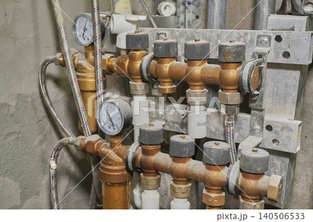 Detailed View of Industrial Plumbing System Featuring Valves, Gauges, and Piping Components 140506533