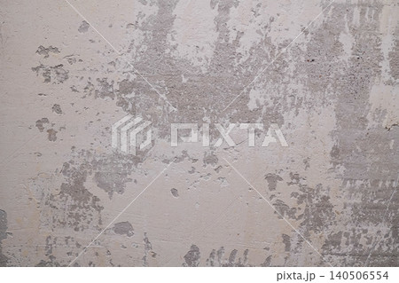 Textured Surface with Visible Paint Peeling and Worn-Out Plaster Revealing Underlying Layers 140506554