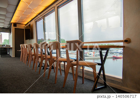 Long table bar counter and chairs in a restaurant 140506717