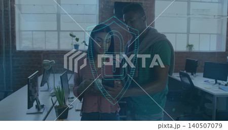 Woman in pink blouse and man in green tee checking smartphone in loft, with shield overlay Woman in pink blouse and man in green tee checking smartphone in loft, with shield overlay 140507079