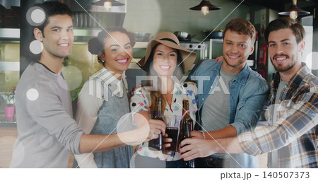 Clinking five adults cheering and toasting at bar counter, with dark bottles and wide-brim hat Clinking five adults cheering and toasting at bar counter, with dark bottles and wide-brim hat 140507373