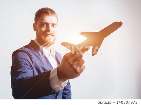 Man proposing signing a life insurance policy, the agent is holding the wooden plane model. 140507978