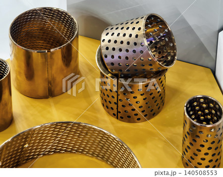 Metal parts are arranged on a yellow surface at a display Metal parts are arranged on a yellow surface at a display 140508553