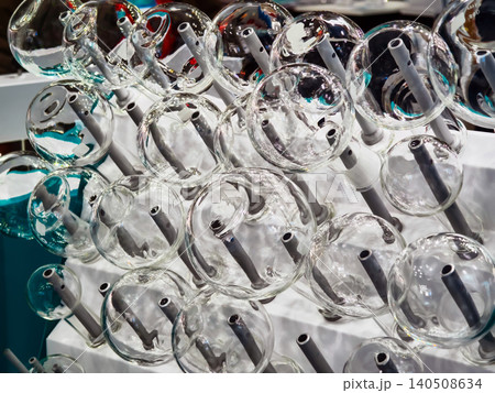Laboratory dryer with multiple glass components arranged systematically on a drying rack during a busy research session Laboratory dryer with multiple glass components arranged systematically on a drying rack during a busy research session 140508634