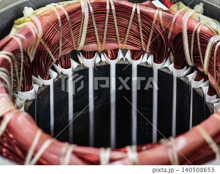 Close view of wire coils and insulation in an industrial motor used in machinery at a factory for power generation Close view of wire coils and insulation in an industrial motor used in machinery at a factory for power generation 140508653