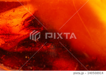 Macro Amber mineral stone on white background Macro Amber mineral stone on white background 140508914