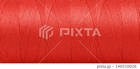Texture of threads in a spool of red color on a white background Texture of threads in a spool of red color on a white background 140510026