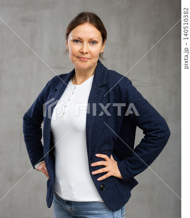 Smiling adult woman posing in jacket Smiling adult woman posing in jacket 140510382