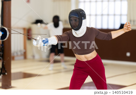 female athlete participates in fencing training fights female athlete participates in fencing training fights 140510419