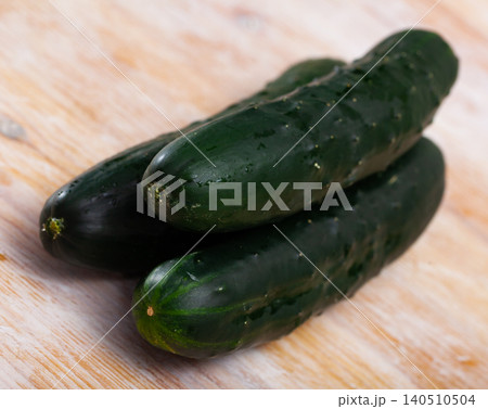 Ripe cucumbers on a wooden table 140510504