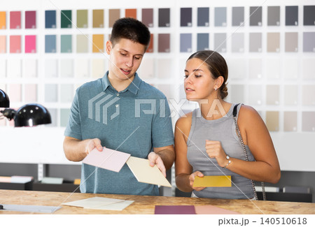 Married couple discussing ceramic tile colors in hardware store Married couple discussing ceramic tile colors in hardware store 140510618