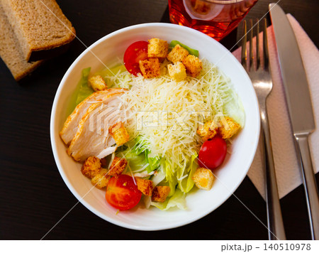 Fresh Caesar salad with chicken on plate 140510978
