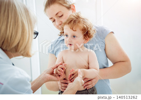 Friendly doctor pediatrician with patient child at clinic Friendly doctor pediatrician with patient child at clinic 140513262