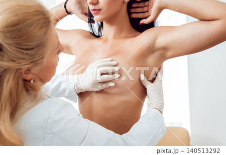 Doctor get examining breast of young woman. Consultation with gynecologist. 140513292