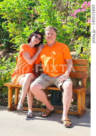 Happy husband and wife posing together for a vacation photo, smiling and enjoying their getaway Happy husband and wife posing together for a vacation photo, smiling and enjoying their getaway 140513893