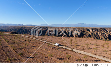 Camper van traveling through Gorafe desert badlands landscape in Spain Camper van traveling through Gorafe desert badlands landscape in Spain 140513924