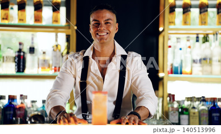 Bartender smiling standing behind bar with drink Bartender smiling standing behind bar with drink 140513996