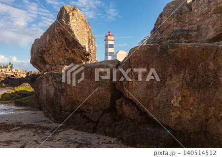Santa Marta Lighthouse Behind Coastal Rocks in Cascais Portugal Santa Marta Lighthouse Behind Coastal Rocks in Cascais Portugal 140514512