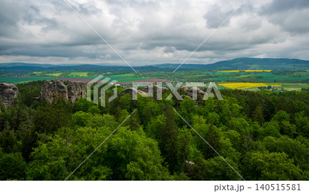 View from the tower of Hruba Skala Castle over the landscape of Bohemian Paradise (Cesky raj), Czech Republic, with silhouette of Trosky Castle ruin in the distance under dramatic soft sky panorama View from the tower of Hruba Skala Castle over the landscape of Bohemian Paradise (Cesky raj), Czech Republic, with silhouette of Trosky Castle ruin in the distance under dramatic soft sky panorama 140515581