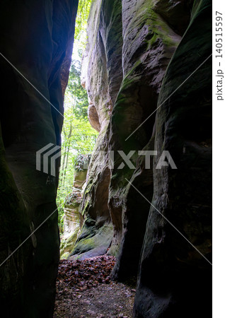 Massive sandstone rock formations along a forest trail in Bohemian Paradise (Cesky raj), Hruba Skala area (Hruboskalsko), Czech Republic, with giant stones rising above woodland path Massive sandstone rock formations along a forest trail in Bohemian Paradise (Cesky raj), Hruba Skala area (Hruboskalsko), Czech Republic, with giant stones rising above woodland path 140515597