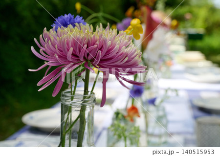 Close u on a flower from a Rustic floral wedding table in the countryside in summer Close u on a flower from a Rustic floral wedding table in the countryside in summer 140515953