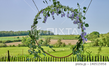 A floral frame circle to celebrate a wedding in the countryside in summer A floral frame circle to celebrate a wedding in the countryside in summer 140515958