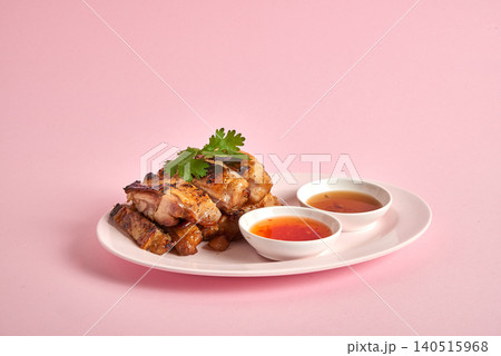 Thai Gai Yang grilled chicken, sliced and served with spicy dipping sauce and fresh cilantro. 140515968