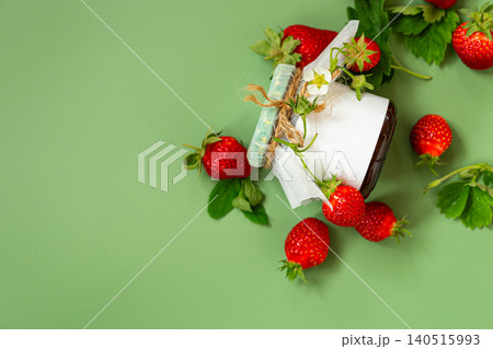 Rustic jar of strawberry jam with berries on pastel green background Rustic jar of strawberry jam with berries on pastel green background 140515993